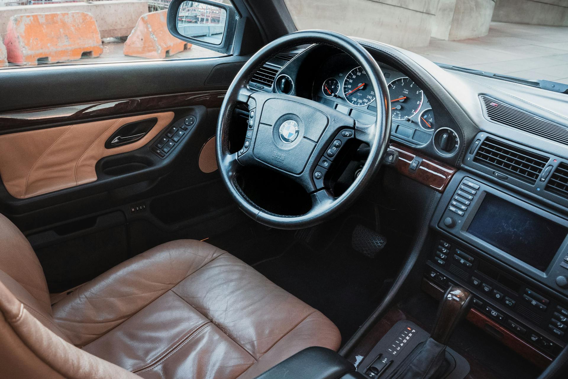 Explore the elegance of a BMW car interior featuring leather seats and sleek dashboard design.