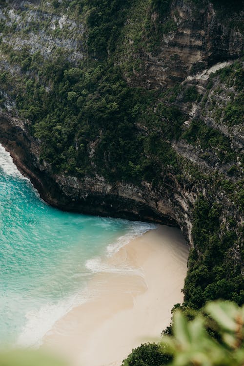 Free White Sand Beach Beside a Mountain Stock Photo