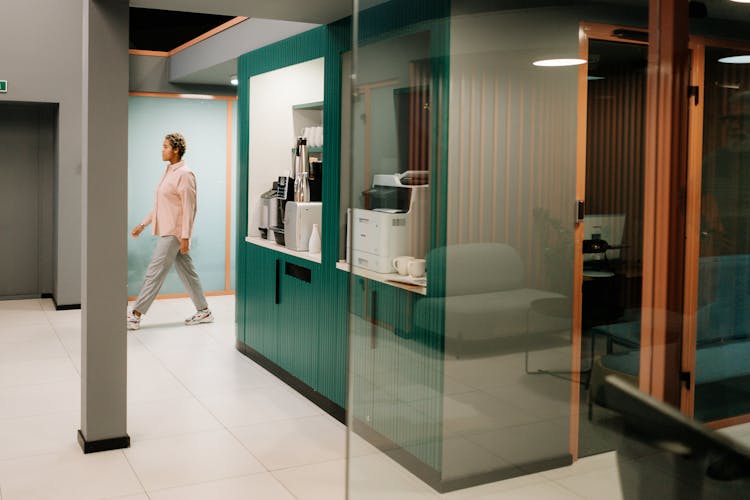 Woman In Pink Long Sleeves Walking At The Office