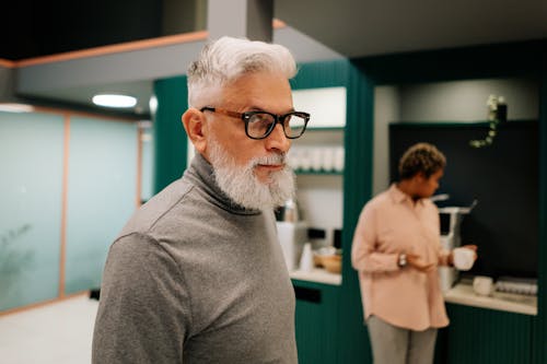 A Man in Gray Sweater Wearing Eyeglasses