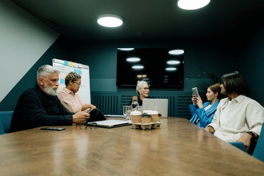 A diverse group of business professionals engaged in a meeting inside a modern conference room.