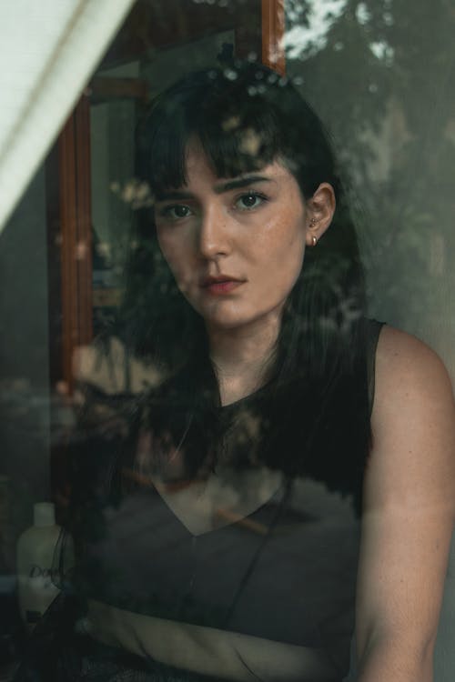 Photo of a Woman Behind Glass