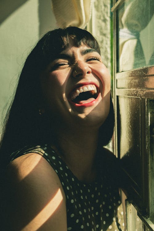 Close Up Photo of a Woman Laughing