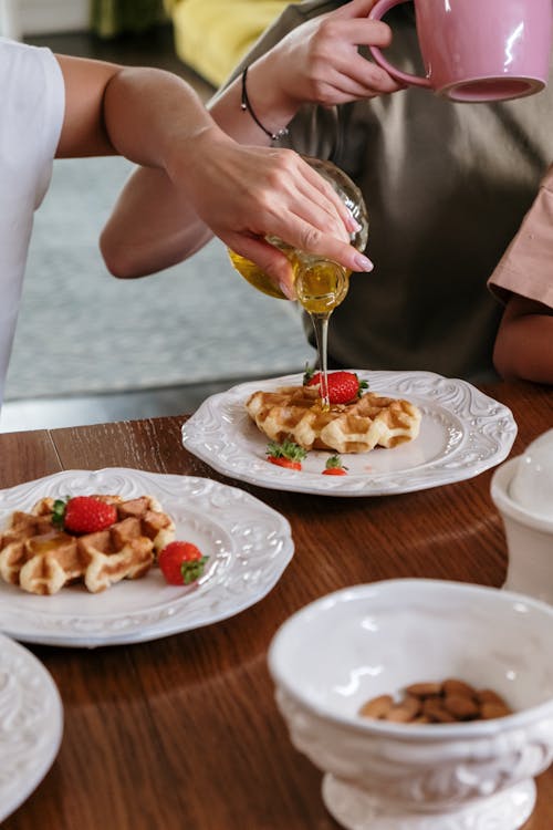 Free Person Pouring Syrup on Waffle Stock Photo
