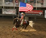 Man Riding Horse Holding Us a Flag