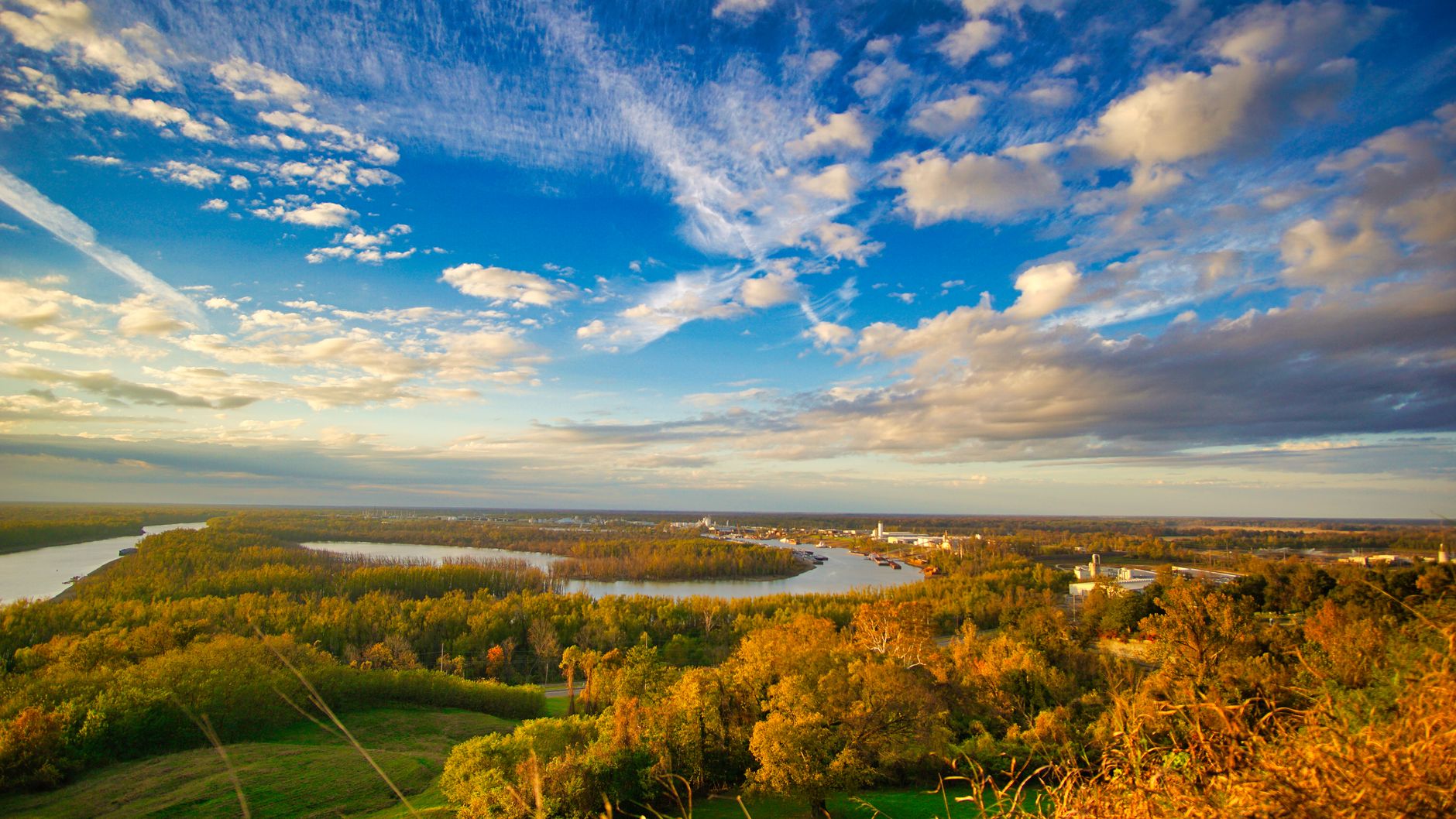 Door hanger delivery in South Bend, IN Door hanger distribution and flyer delivery in South Bend, IN — Scenic aerial view of the Mississippi River at sunset, showcasing lush greenery and clear skies. above neighborhoods DoorBlitz crews walk