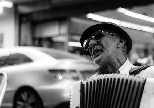 Free Grayscale Photo of an Elderly Man Playing Accordion Stock Photo