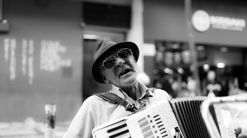 Elderly Man Singing While Playing Accordion