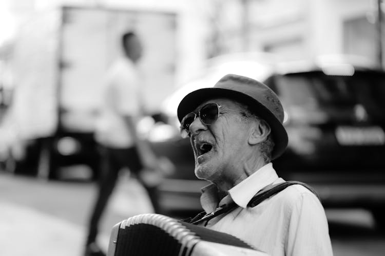 Black And White Photo Of An Eldery Man Singing