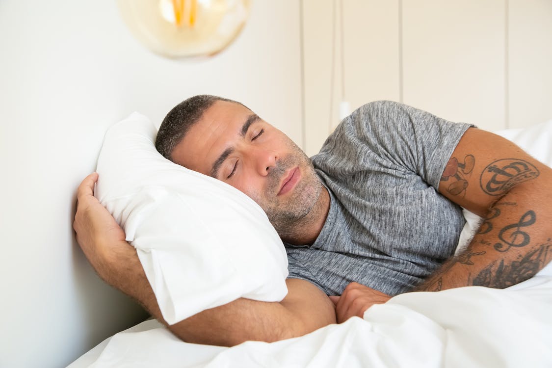 Man Sleeping with Pillow between Legs Stock Photo - Image of bedding,  prevent: 245556014