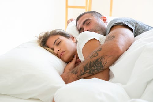 Free Man Huggug a Woman While Sleeping Stock Photo