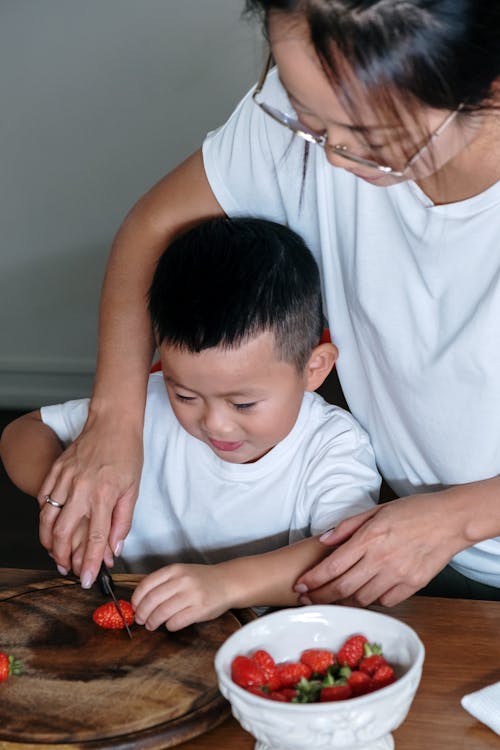 Free Mother and Son Slicing a Strawberry Stock Photo