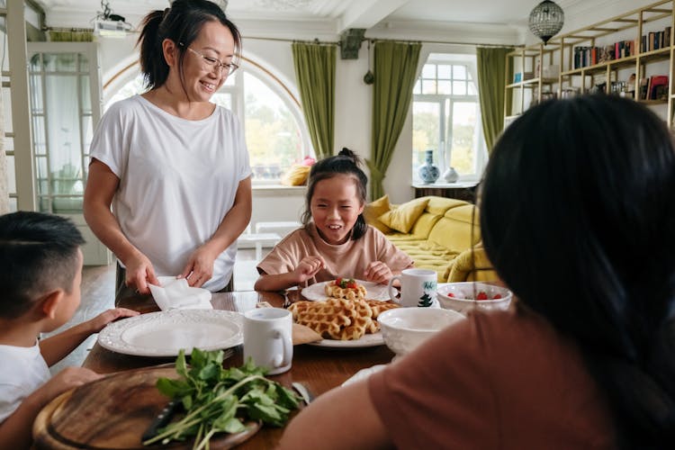 Family Eating Fresh Waffles Together
