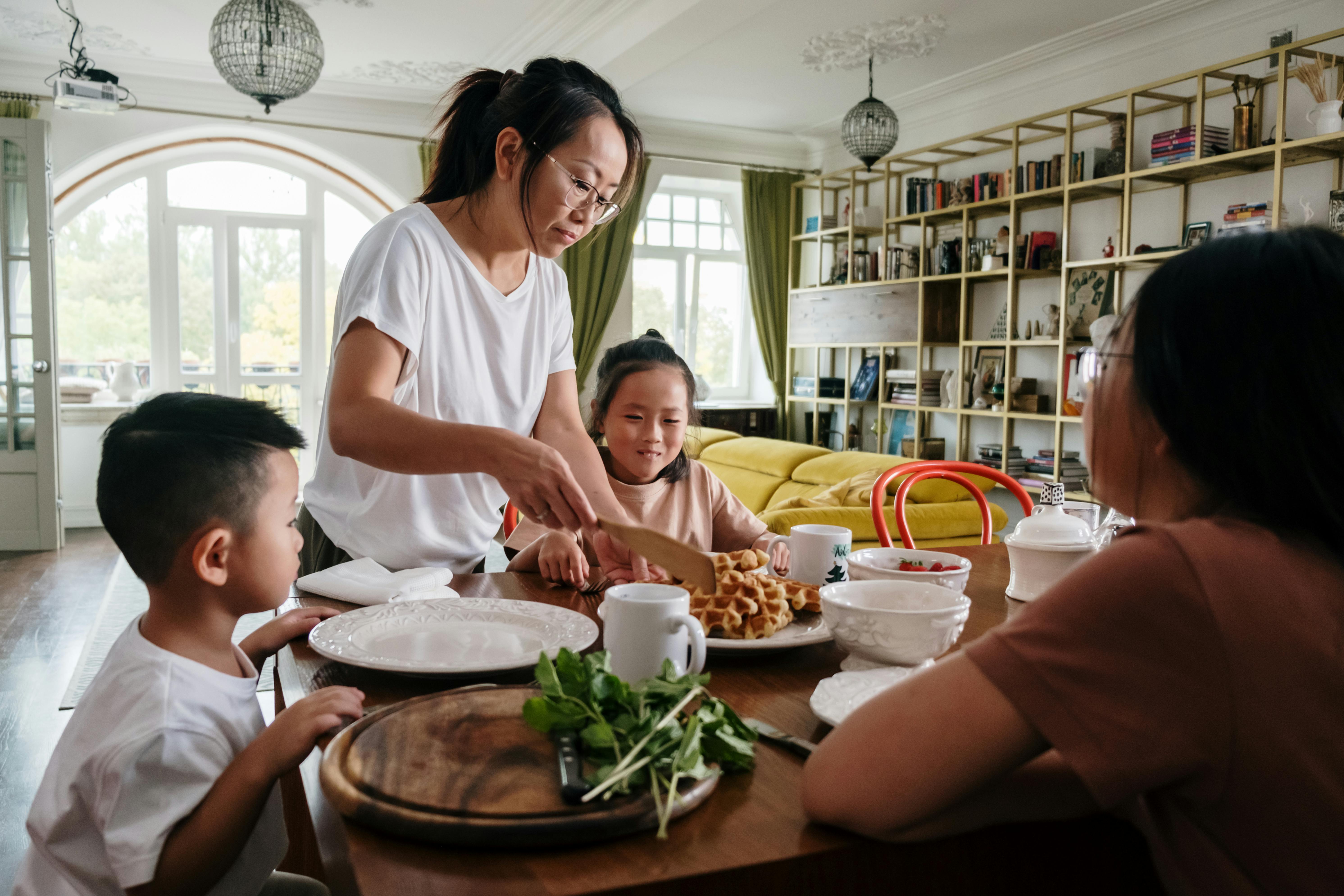 woman serving waffles to the kids