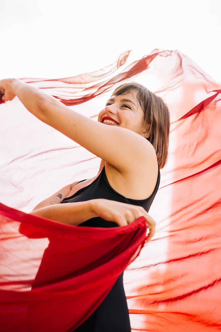 Happy Woman Holding A Red Cloth