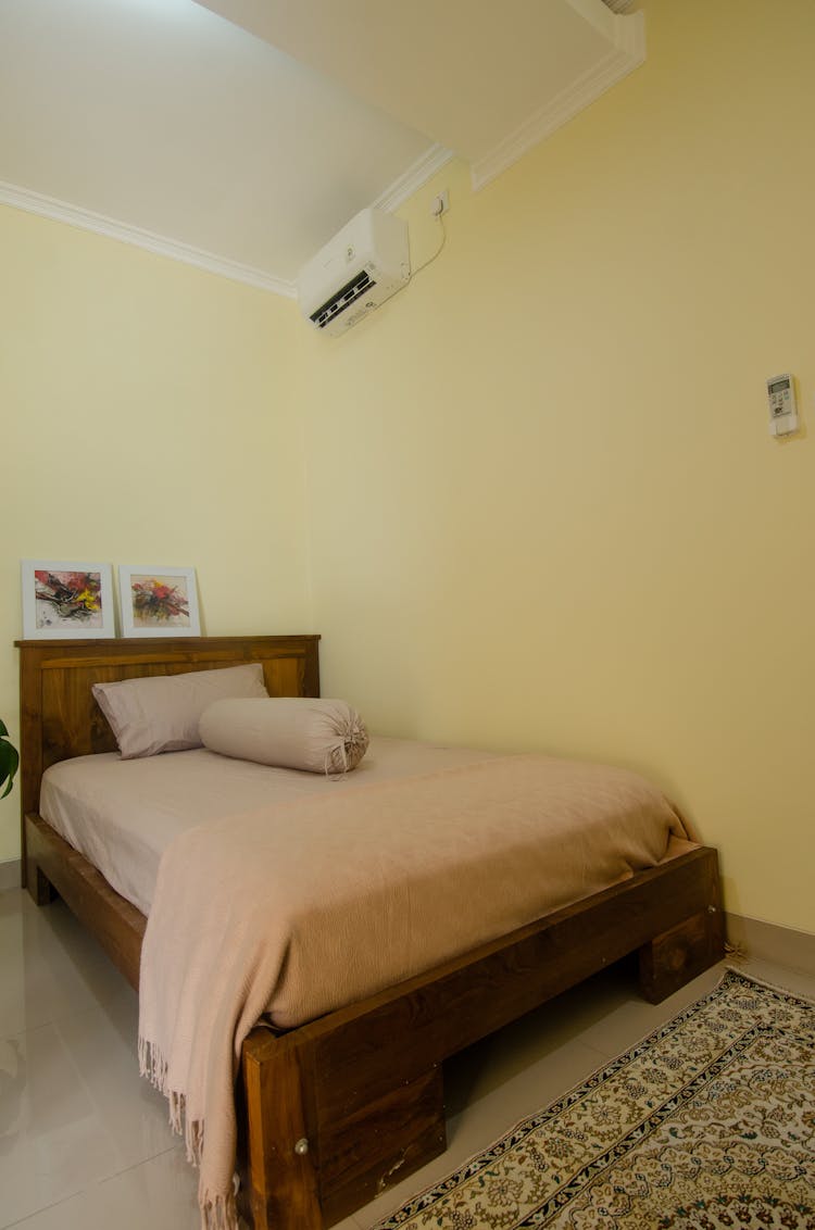 A Cozy Bed Near The Wall With Split Type Aircon