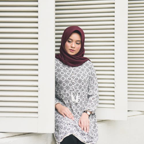 Woman Wearing Hijab Sitting Beside Windows