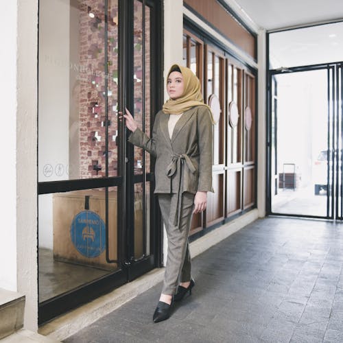 Woman Wearing Hijab Standing Near Glass Door