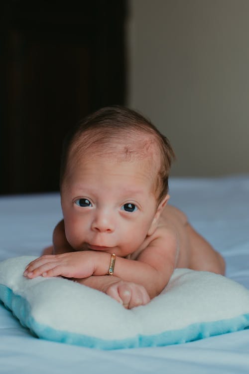 Free Baby Lying on a Pillow Stock Photo