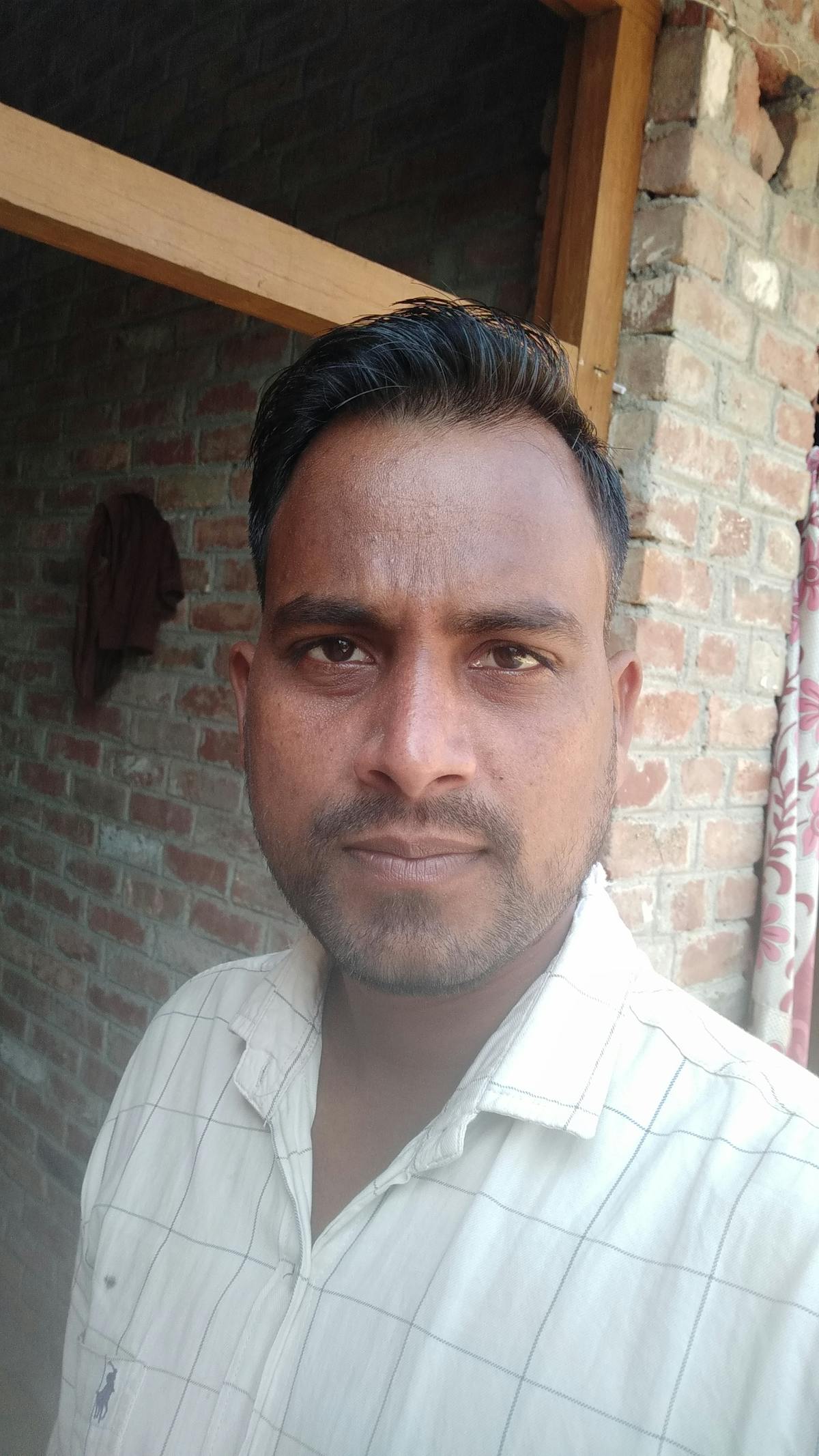 Person journaling at a table with water and tea, creating a plan