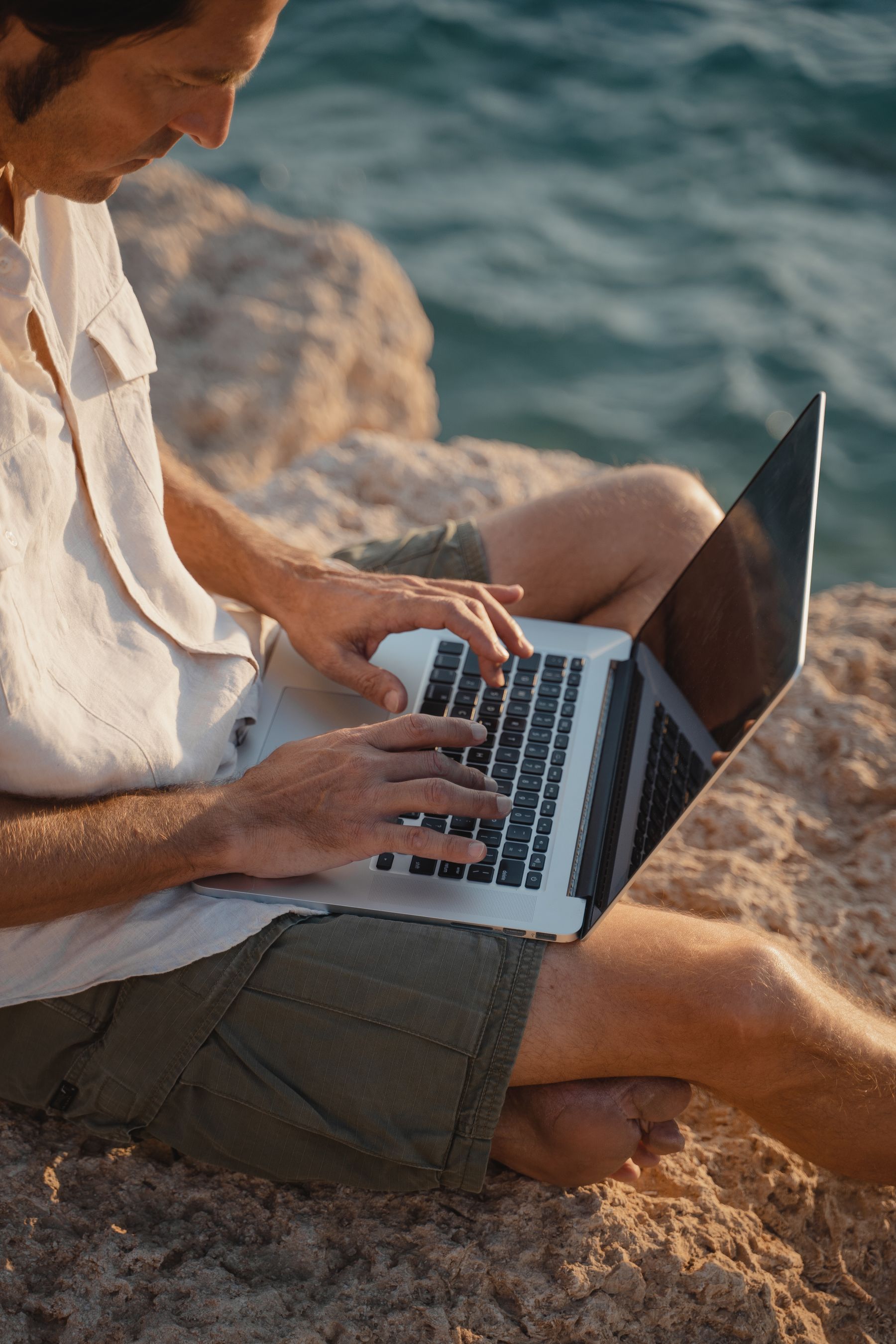 Remote worker using a laptop by the sea