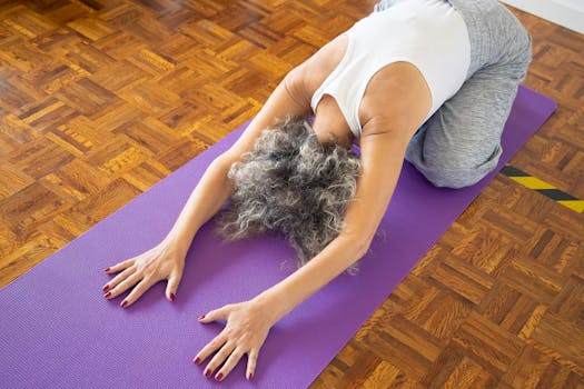 Elderly woman performing yoga pose on a purple mat, promoting wellness and relaxation.