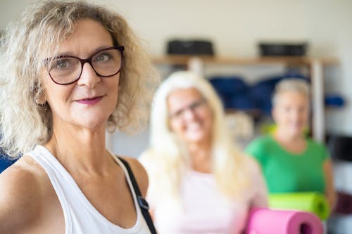 An Elderly Woman in White Tank Top Wearing Eyeglasses