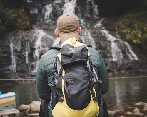 Close Up Photo of a Man Carrying a Backpack