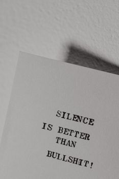 Monochrome image of a bold quote highlighting the value of silence over noise.