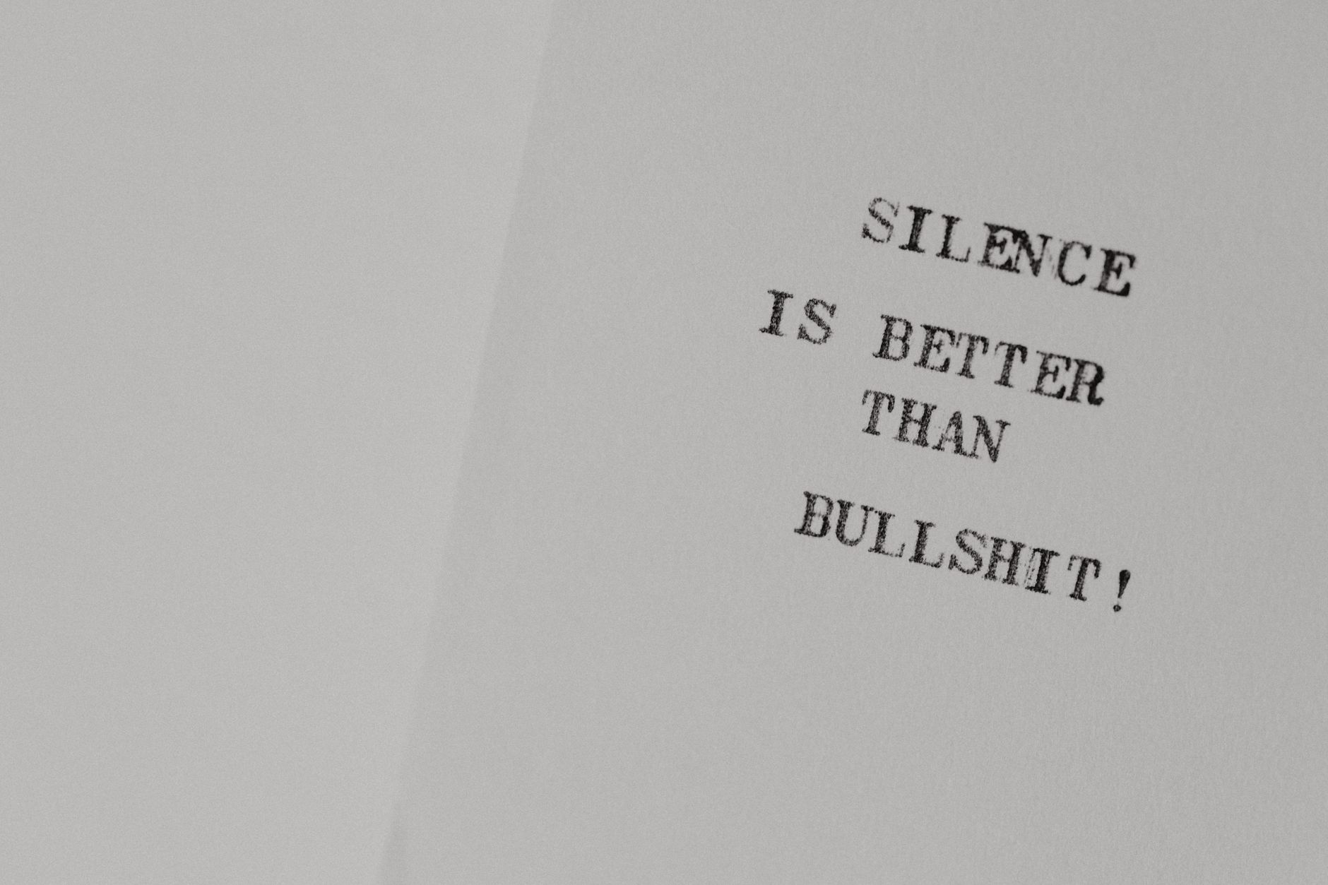 Minimalist design featuring the quote 'Silence is better than bullshit' on white paper.