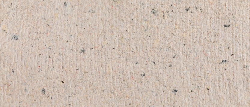 Close-up of flecked recycled paper — photo by kaboompics.com on Pexels
