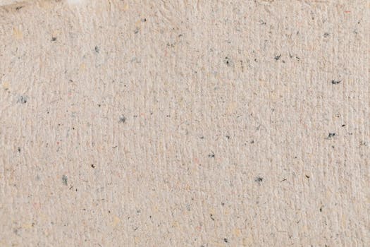 High-resolution beige paper texture with visible fibers, perfect for backgrounds.