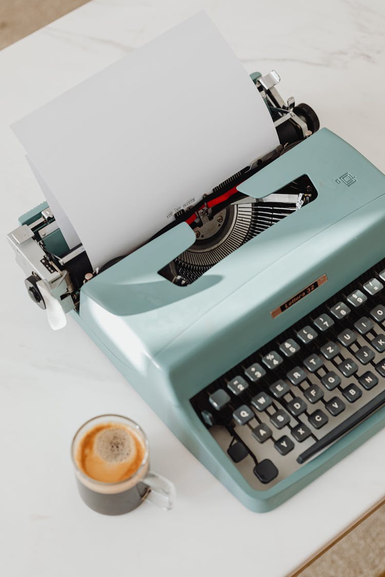 Vintage Typewriter And Coffee On A Table