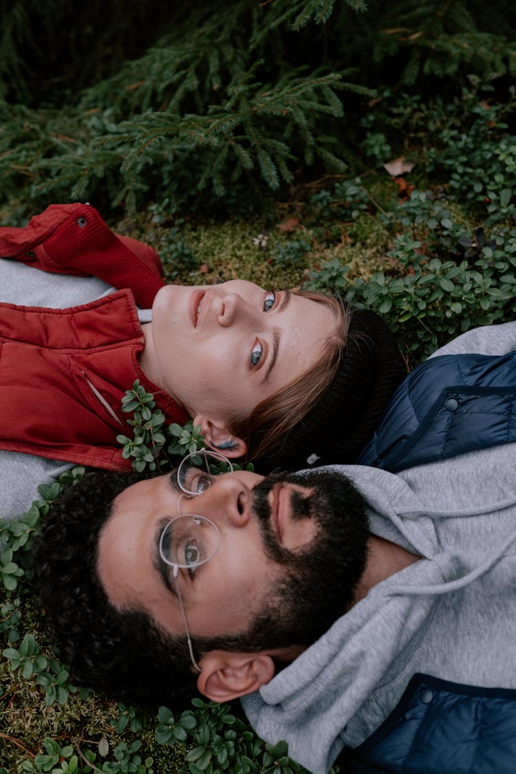 Couple Lying On Forest Floor