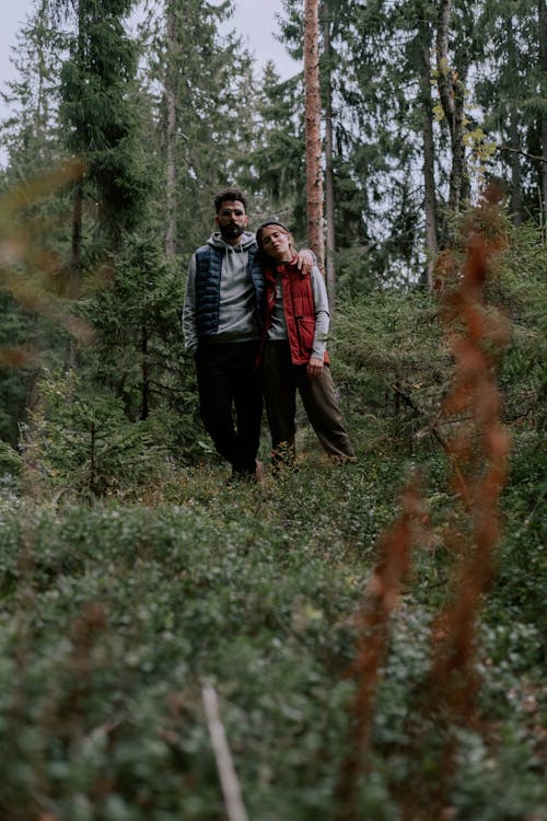 A Couple Standing Near Trees