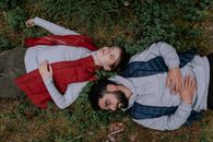 2 Women Lying on Ground Covered With Dried Leaves
