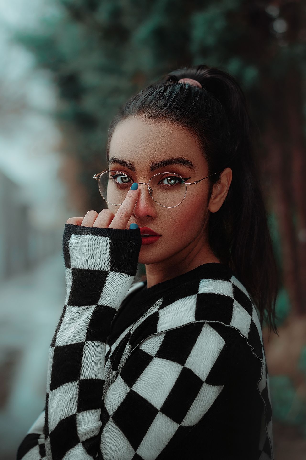 Close up of a black and white checkerboard knit sweater sleeve and shoulder