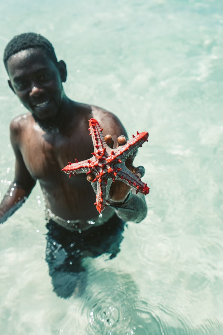 A Man Holding A Sea Star