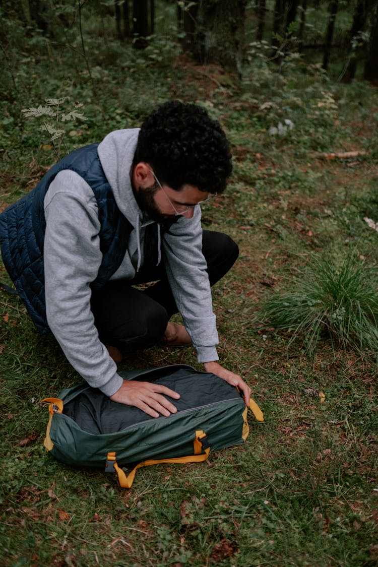 Man In Gray Hoodie Holding A Bag