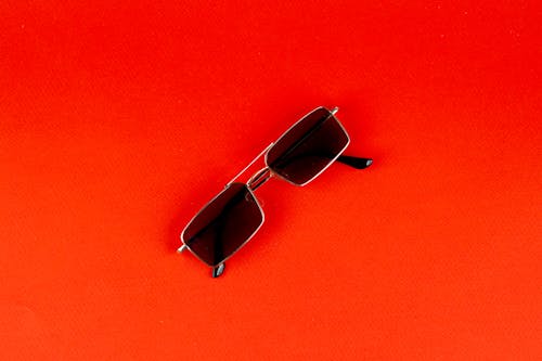 Sunglasses on Orange Surface