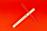 White and Black Stick on Red Textile