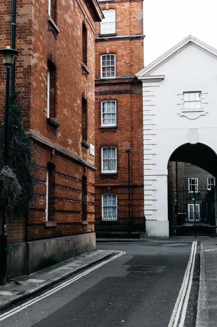 Charming alleyway in London featuring classic brick architecture under a serene sky.