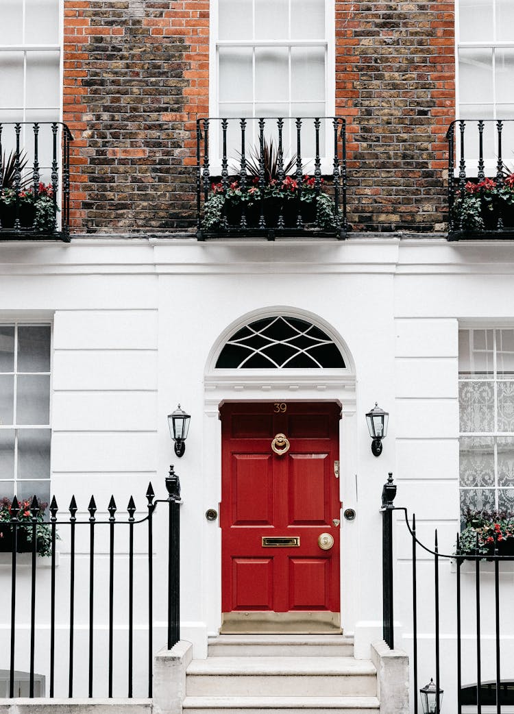 Facade Of Residential Building With Red Door