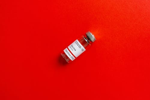 A Vial on a Red Surface 