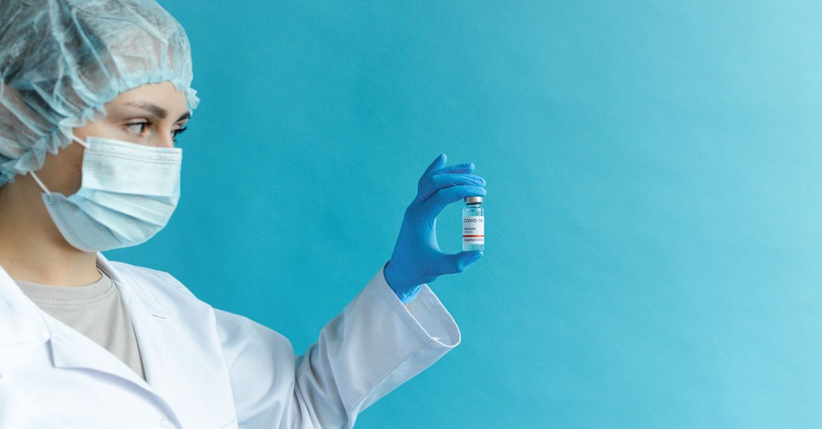 Female doctor in protective gear holding a vaccine vial against a blue background. - Evidence evidence guide for bovine colostrum immune support randomized trial