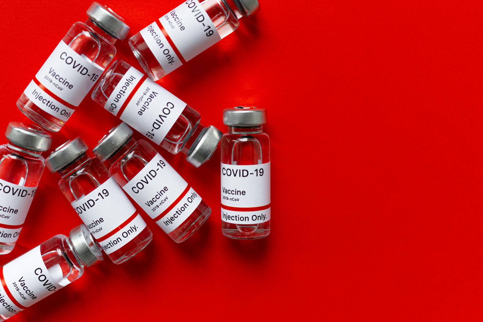 Covid 19 Vaccines on Red Surface