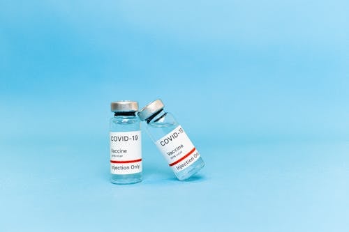 Covid Vaccine Bottles on Blue Surface