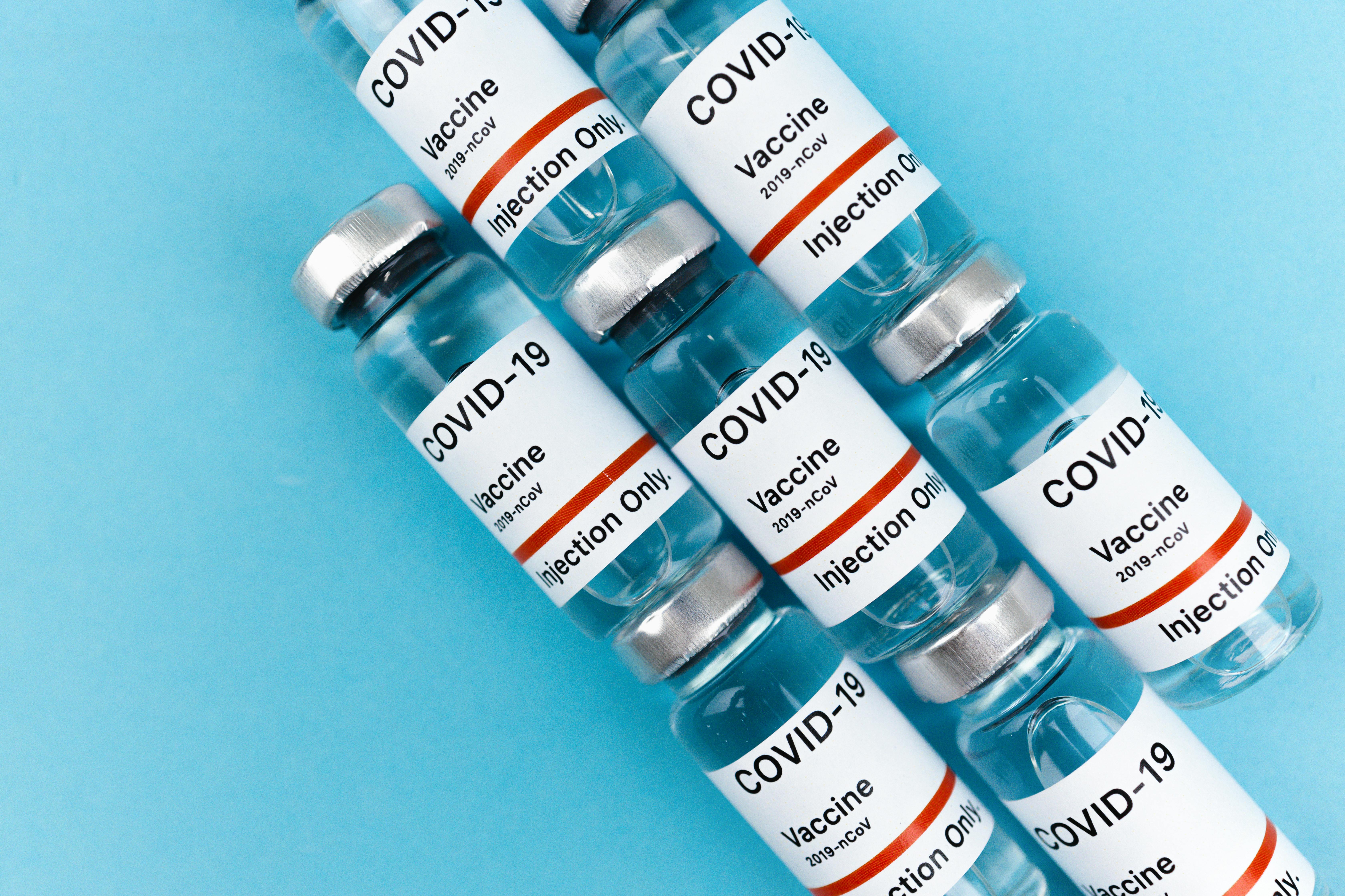 covid vaccines on blue surface