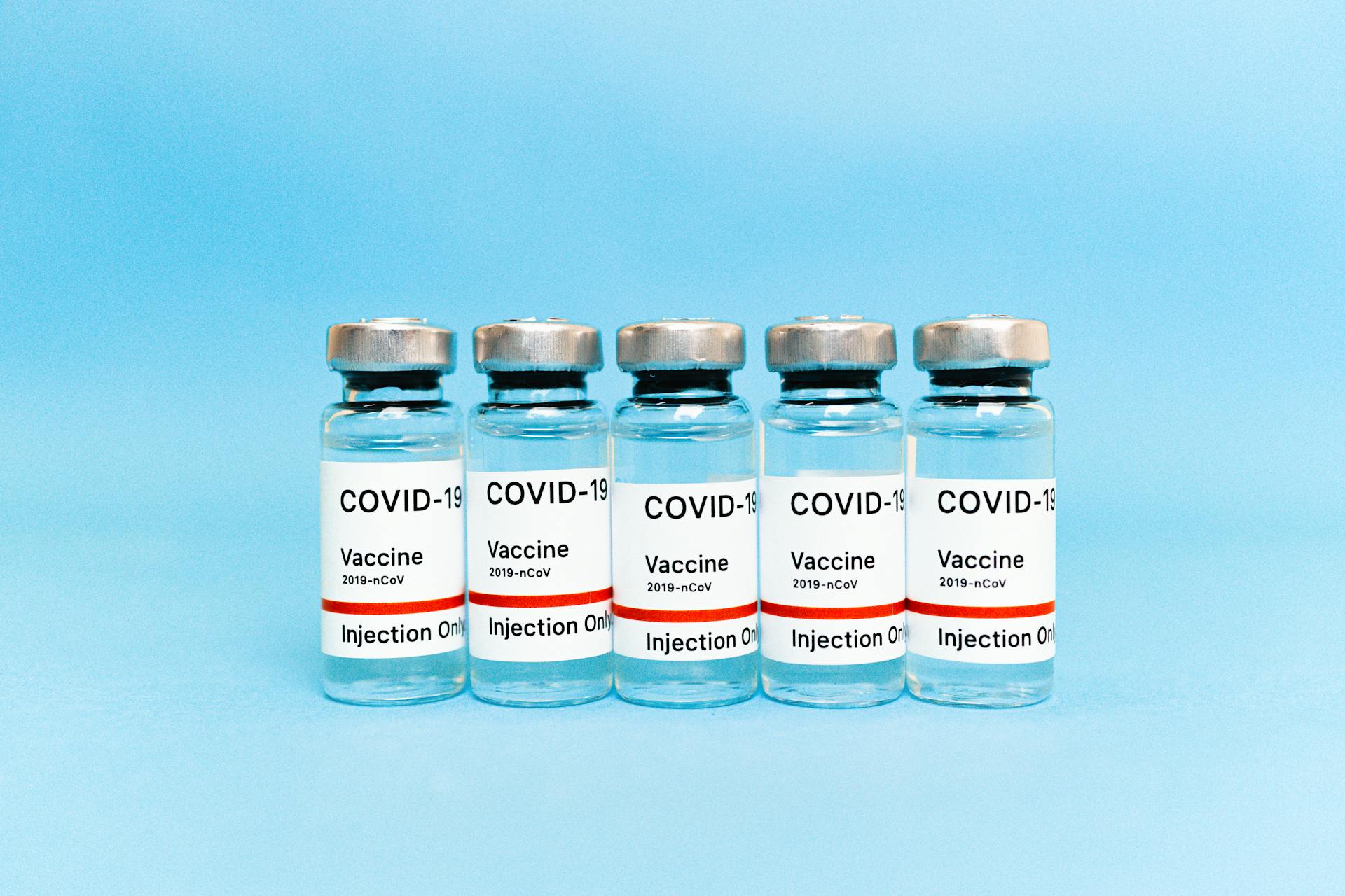 Vaccine Bottles on Blue Background