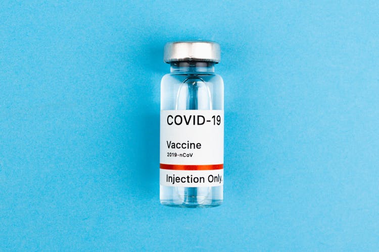 Vaccine Ampoule On Light Blue Background
